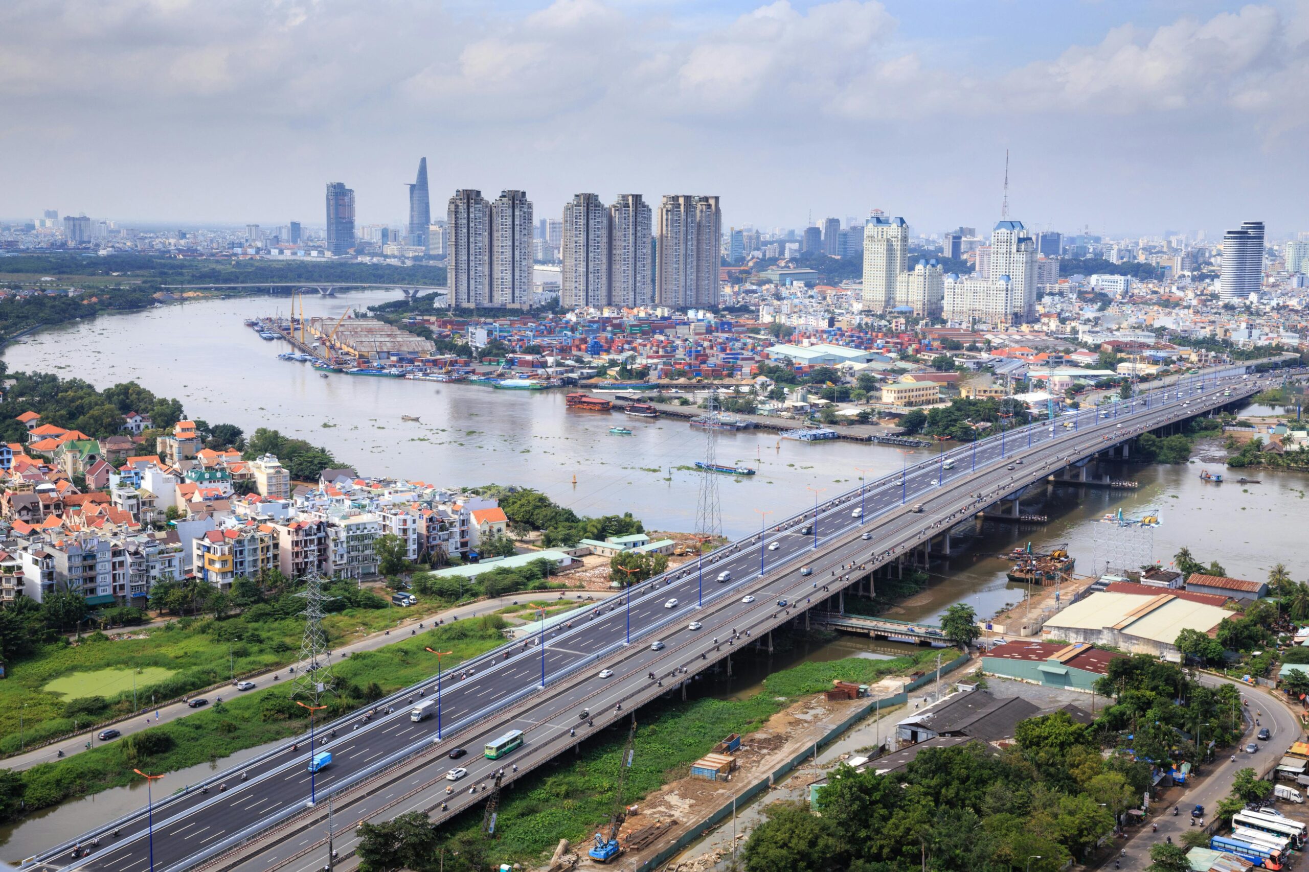 An aerial shot showcasing the skyline and river of Ho Chi Minh City, highlighting its urban landscape.