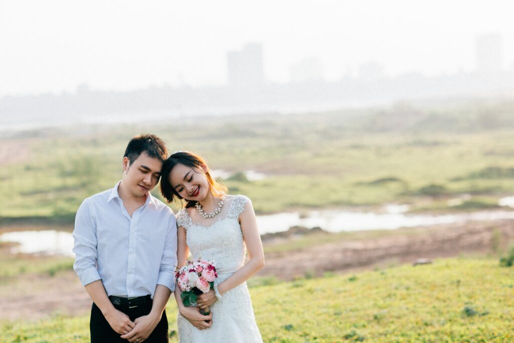 A joyful couple celebrating their wedding outdoors in Hà Nội, Việt Nam.